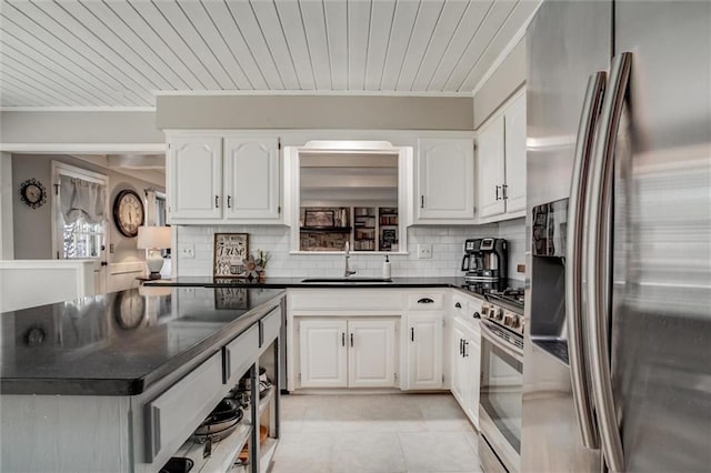 9718 W 115th Ter, Overland Park, KS 66210 - kitchen with stainless steel appliances, dark countertops, tasteful backsplash, white cabinetry, and ornamental molding