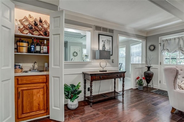 9718 W 115th Ter, Overland Park, KS 66210 - indoor wet bar with dark wood-type flooring, a decorative wall, and crown molding
