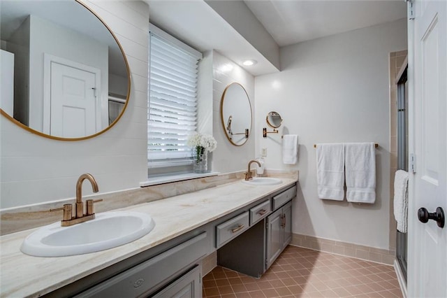 9718 W 115th Ter, Overland Park, KS 66210 - bathroom featuring double vanity, tile patterned flooring, and a shower with door