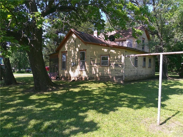 1022 Sycamore St, Humboldt, KS 66748 - bungalow with a front lawn and a chimney