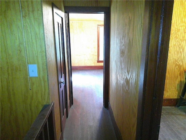 1022 Sycamore St, Humboldt, KS 66748 - hallway featuring hardwood / wood-style floors and wooden walls