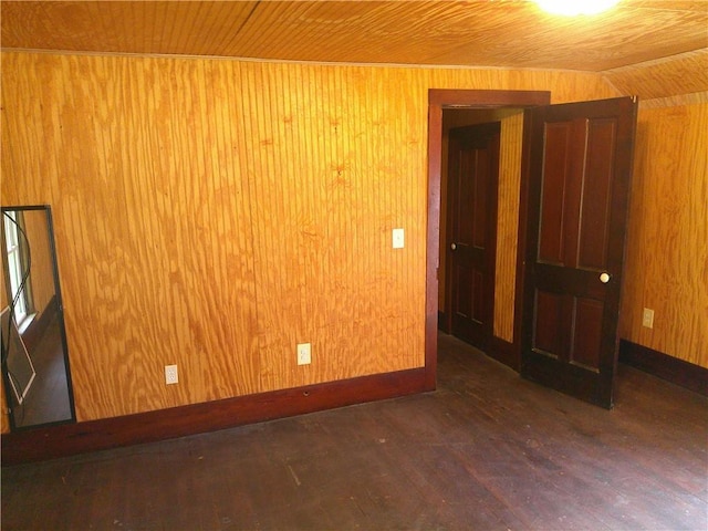 1022 Sycamore St, Humboldt, KS 66748 - empty room featuring wood walls, wood finished floors, and wooden ceiling