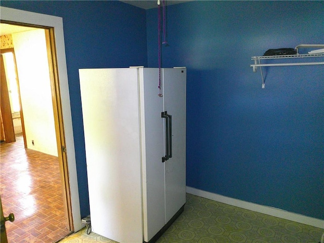 1022 Sycamore St, Humboldt, KS 66748 - kitchen featuring freestanding refrigerator and baseboards