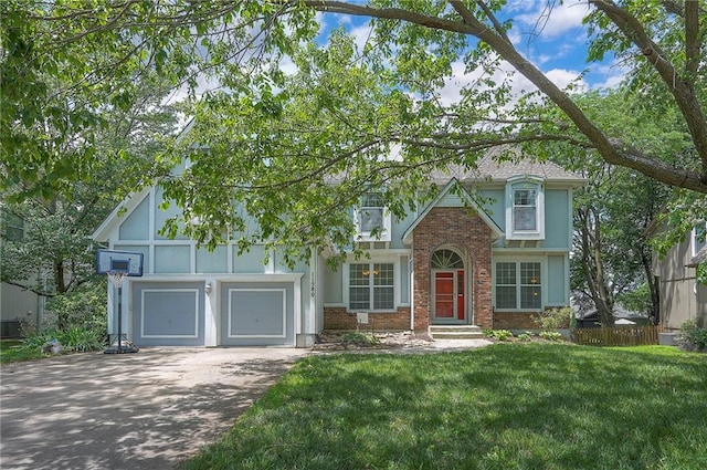 11580 S Skyview Ln, Olathe, KS 66061 - tudor house featuring brick siding, asphalt driveway, a front yard, and a garage
