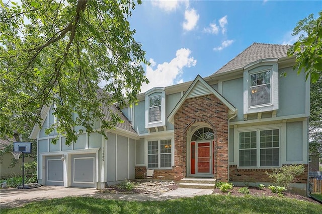 11580 S Skyview Ln, Olathe, KS 66061 - view of front facade with brick siding, driveway, roof with shingles, stucco siding, and board and batten siding