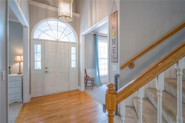 11580 S Skyview Ln, Olathe, KS 66061 - foyer entrance with stairway, crown molding, plenty of natural light, light colored carpet, and a chandelier