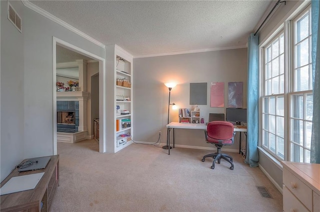 11580 S Skyview Ln, Olathe, KS 66061 - carpeted home office featuring a fireplace, a textured ceiling, ornamental molding, and built in shelves