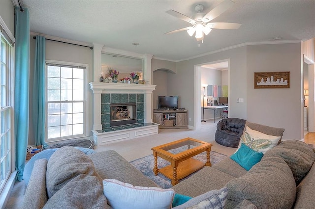 11580 S Skyview Ln, Olathe, KS 66061 - carpeted living area featuring a ceiling fan, crown molding, and a fireplace