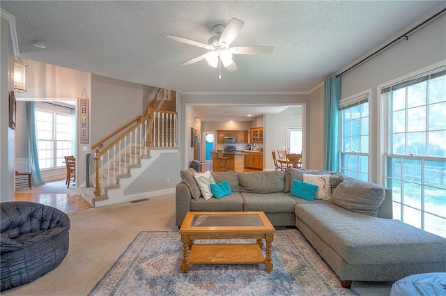 11580 S Skyview Ln, Olathe, KS 66061 - carpeted living room with stairs, a textured ceiling, and ceiling fan