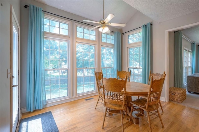 11580 S Skyview Ln, Olathe, KS 66061 - dining space featuring a textured ceiling, light wood-type flooring, ceiling fan, and vaulted ceiling