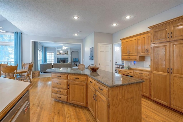 11580 S Skyview Ln, Olathe, KS 66061 - kitchen with a textured ceiling, light wood-style floors, a kitchen island, open floor plan, and recessed lighting