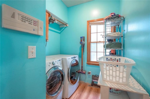 11580 S Skyview Ln, Olathe, KS 66061 - laundry area with separate washer and dryer, wood finished floors, and plenty of natural light