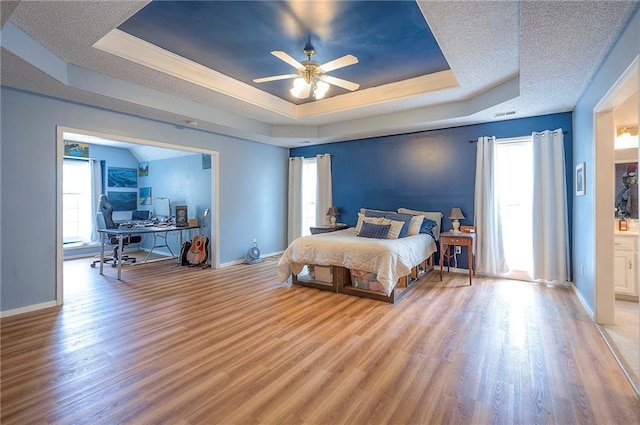 11580 S Skyview Ln, Olathe, KS 66061 - bedroom featuring a raised ceiling, wood finished floors, a desk, and multiple windows