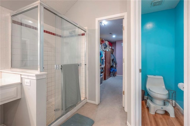 11580 S Skyview Ln, Olathe, KS 66061 - full bath featuring a stall shower, a walk in closet, and a textured ceiling
