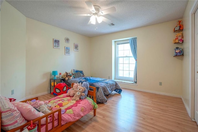 11580 S Skyview Ln, Olathe, KS 66061 - bedroom with wood finished floors, a textured ceiling, and ceiling fan