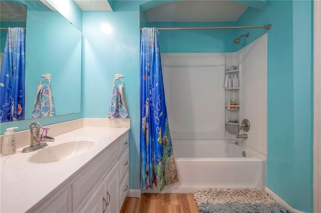11580 S Skyview Ln, Olathe, KS 66061 - bathroom with vanity, shower / bathtub combination with curtain, and wood finished floors