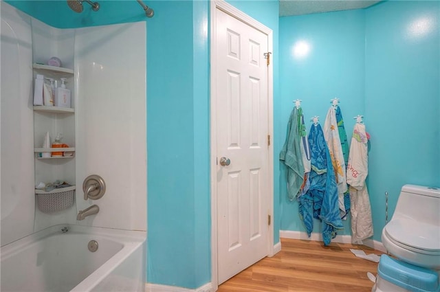 11580 S Skyview Ln, Olathe, KS 66061 - bathroom featuring tub / shower combination and wood finished floors