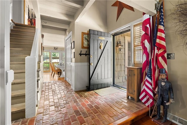 200 NE Oak Tree Cir, Lees Summit, MO 64086 - entrance foyer with brick floors, stairway, and wainscoting