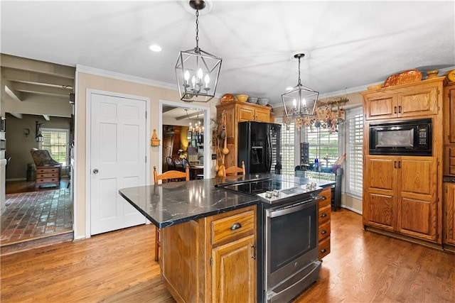 200 NE Oak Tree Cir, Lees Summit, MO 64086 - kitchen featuring black appliances, a chandelier, hanging light fixtures, light wood-type flooring, and a kitchen island
