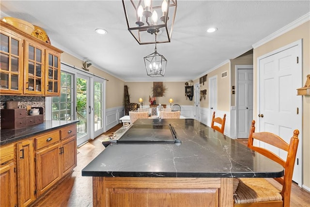 200 NE Oak Tree Cir, Lees Summit, MO 64086 - dining area featuring a chandelier, crown molding, recessed lighting, wainscoting, and light wood-type flooring