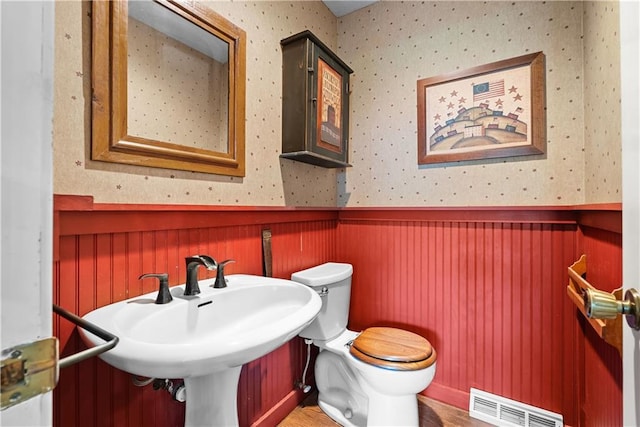 200 NE Oak Tree Cir, Lees Summit, MO 64086 - bathroom with a wainscoted wall, wallpapered walls, and wood finished floors