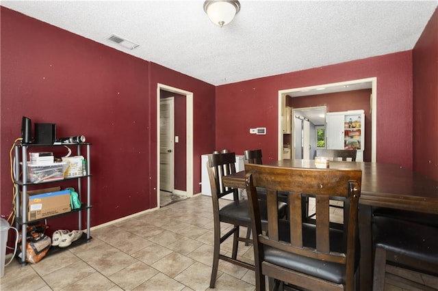 2716 S 52nd St, Kansas City, KS 66106 - dining area with tile patterned flooring and a textured ceiling