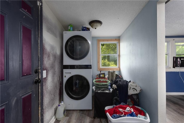 2716 S 52nd St, Kansas City, KS 66106 - washroom featuring stacked washer and clothes dryer, a textured ceiling, and wood finished floors