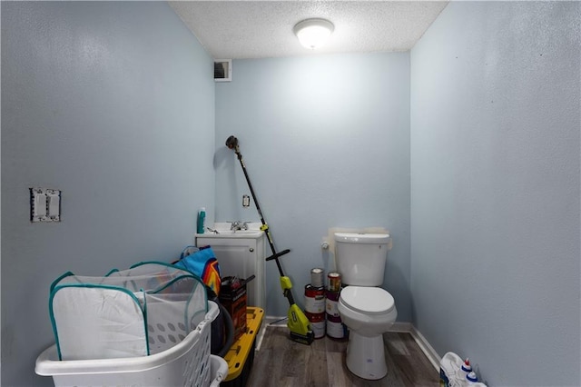 2716 S 52nd St, Kansas City, KS 66106 - bathroom featuring vanity, wood finished floors, and a textured ceiling