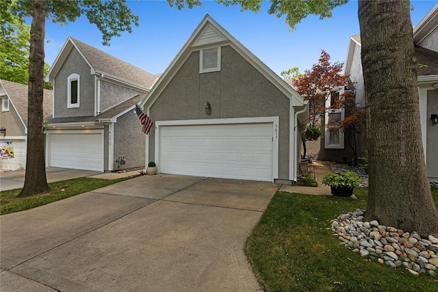 5817 Park Cir, Shawnee, KS 66216 - traditional-style house with a garage, stucco siding, and driveway