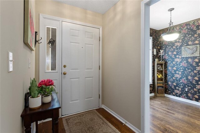 5817 Park Cir, Shawnee, KS 66216 - foyer with wallpapered walls and wood finished floors