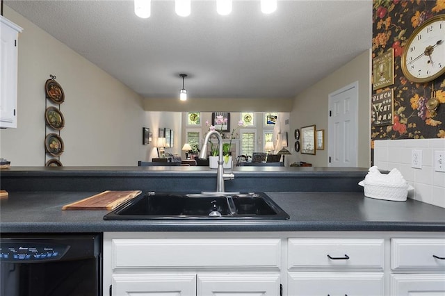 5817 Park Cir, Shawnee, KS 66216 - kitchen with dishwasher, dark countertops, white cabinets, open floor plan, and a textured ceiling