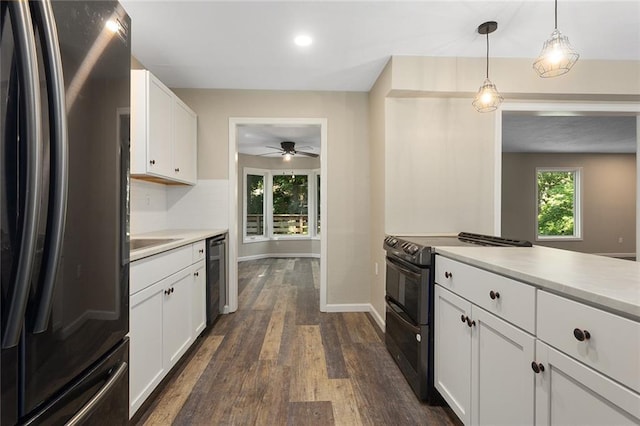 7421 NW 76th Ter, Kansas City, MO 64152 - kitchen with freestanding refrigerator, electric range, light countertops, dark wood-style flooring, and white cabinetry