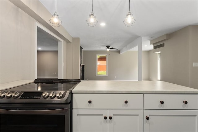 7421 NW 76th Ter, Kansas City, MO 64152 - kitchen featuring stainless steel electric stove, ceiling fan, white cabinets, and light countertops
