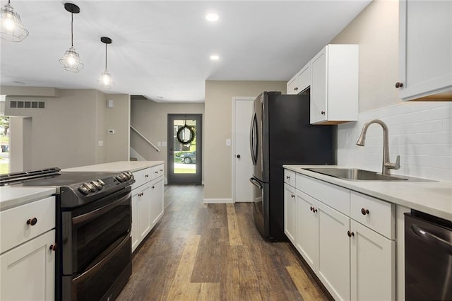 7421 NW 76th Ter, Kansas City, MO 64152 - kitchen with stainless steel appliances, dark wood finished floors, white cabinetry, hanging light fixtures, and recessed lighting