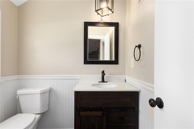 7421 NW 76th Ter, Kansas City, MO 64152 - bathroom featuring a wainscoted wall and vanity