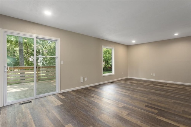 7421 NW 76th Ter, Kansas City, MO 64152 - empty room with healthy amount of natural light, dark wood finished floors, and recessed lighting