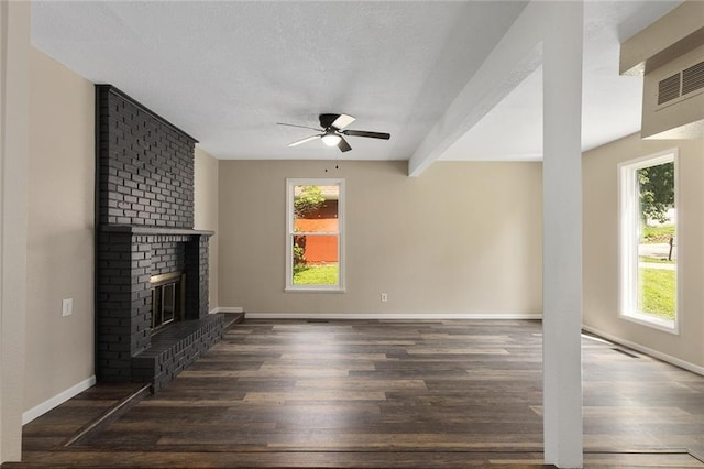 7421 NW 76th Ter, Kansas City, MO 64152 - unfurnished living room featuring a ceiling fan, wood finished floors, plenty of natural light, and a textured ceiling