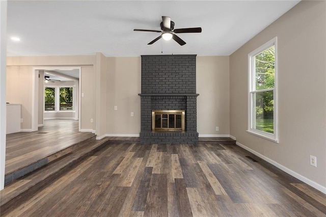 7421 NW 76th Ter, Kansas City, MO 64152 - unfurnished living room with a ceiling fan, wood finished floors, and plenty of natural light