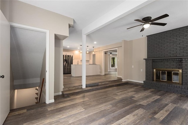 7421 NW 76th Ter, Kansas City, MO 64152 - unfurnished living room with a ceiling fan, wood finished floors, a fireplace, recessed lighting, and stairway