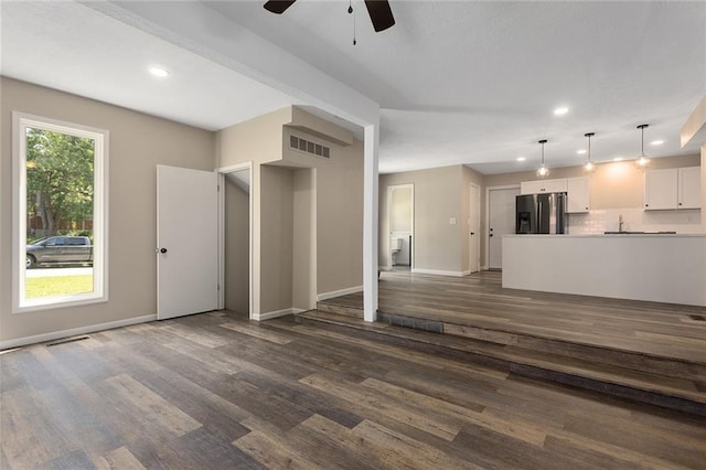 7421 NW 76th Ter, Kansas City, MO 64152 - unfurnished living room with ceiling fan, dark wood-style floors, and recessed lighting