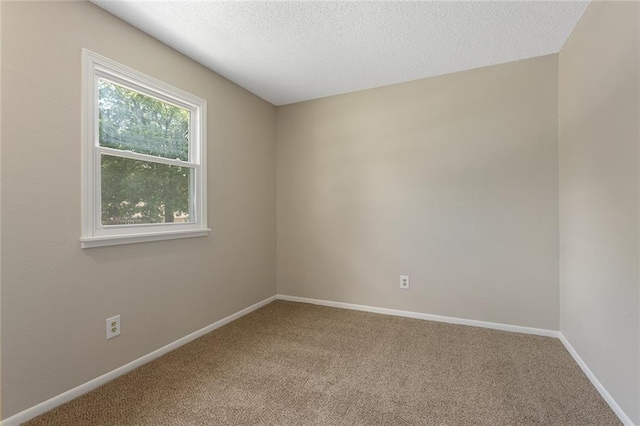 7421 NW 76th Ter, Kansas City, MO 64152 - carpeted spare room with baseboards and a textured ceiling