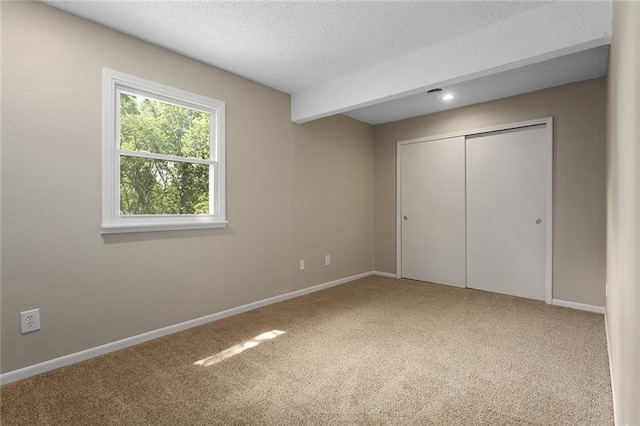 7421 NW 76th Ter, Kansas City, MO 64152 - unfurnished bedroom with carpet floors, a closet, and a textured ceiling