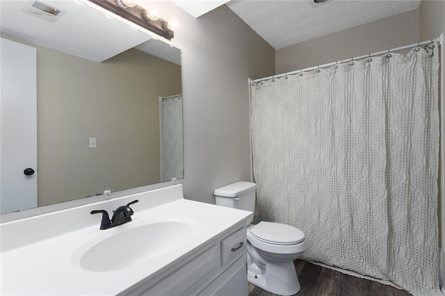 7421 NW 76th Ter, Kansas City, MO 64152 - bathroom featuring wood finished floors, vanity, and a textured ceiling