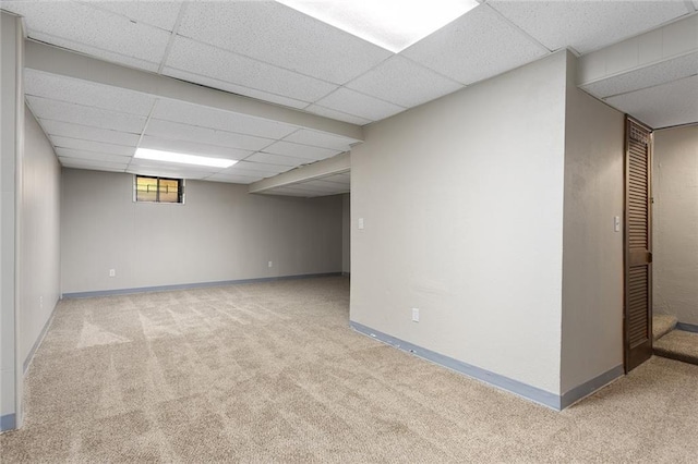 7421 NW 76th Ter, Kansas City, MO 64152 - below grade area featuring a paneled ceiling and carpet floors