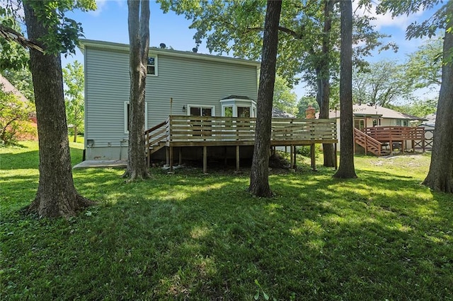 7421 NW 76th Ter, Kansas City, MO 64152 - back of house featuring a wooden deck, a yard, and stairway