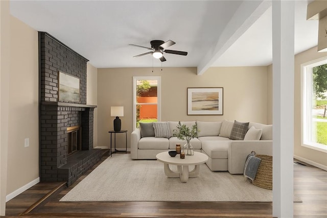 7421 NW 76th Ter, Kansas City, MO 64152 - living area with dark wood-style floors, ceiling fan, healthy amount of natural light, and a fireplace