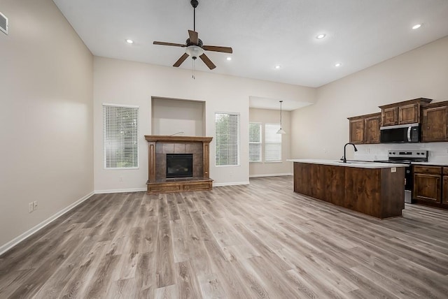 20444 W 125th Ter, Olathe, KS 66061 - kitchen with stainless steel appliances, light wood finished floors, a ceiling fan, open floor plan, and recessed lighting