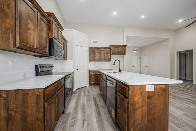 20444 W 125th Ter, Olathe, KS 66061 - kitchen with stainless steel appliances, light wood-style flooring, tasteful backsplash, light countertops, and recessed lighting