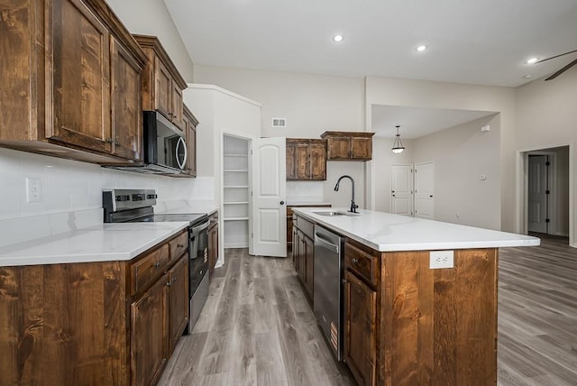 20444 W 125th Ter, Olathe, KS 66061 - kitchen featuring appliances with stainless steel finishes, wood finished floors, tasteful backsplash, light countertops, and recessed lighting