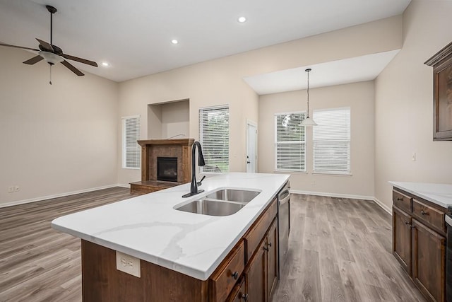20444 W 125th Ter, Olathe, KS 66061 - kitchen featuring a tiled fireplace, light wood-type flooring, open floor plan, pendant lighting, and recessed lighting